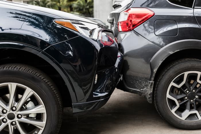 Two bumpers damaged from a car accident